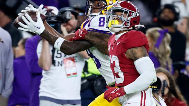 LSU Tigers wide receiver Malik Nabers (8) catches a pass over Alabama Crimson Tide defensive back Malachi Moore (13) during the second half at Bryant-Denny Stadium.